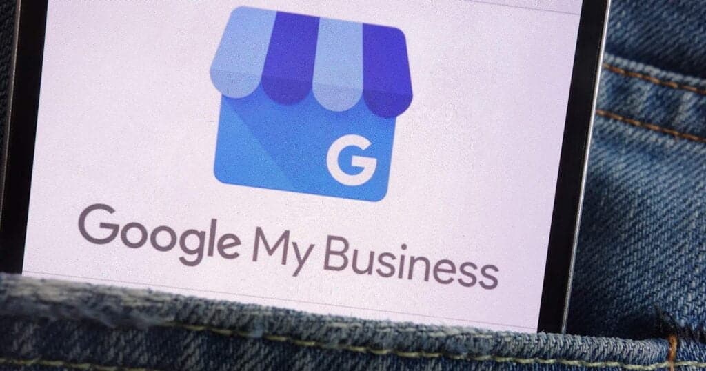 Google My Business logo displayed on a smartphone screen, involving local SEO and business visibility for Oshawa, Durham Region, and Bowmanville web design services.