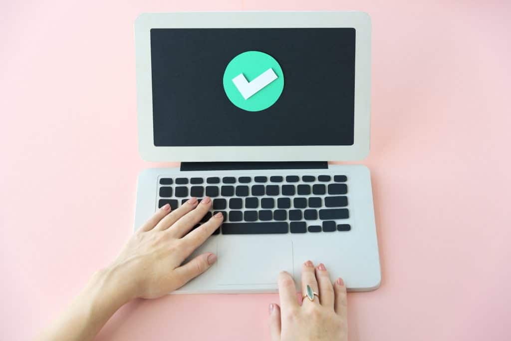 Verified computer screen with a checkmark symbol indicating successful web design completion.