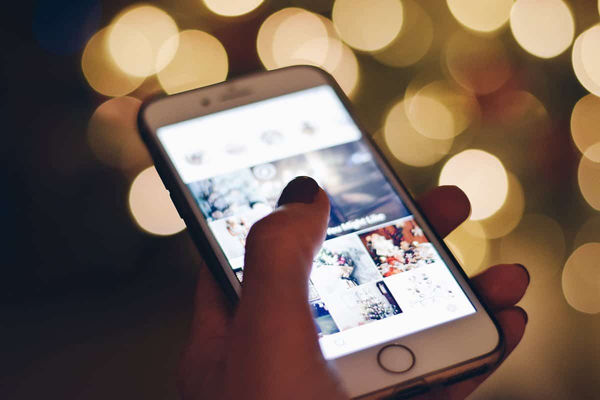 User-generated content on a smartphone with a blurred festive background, highlighting social media and digital engagement.