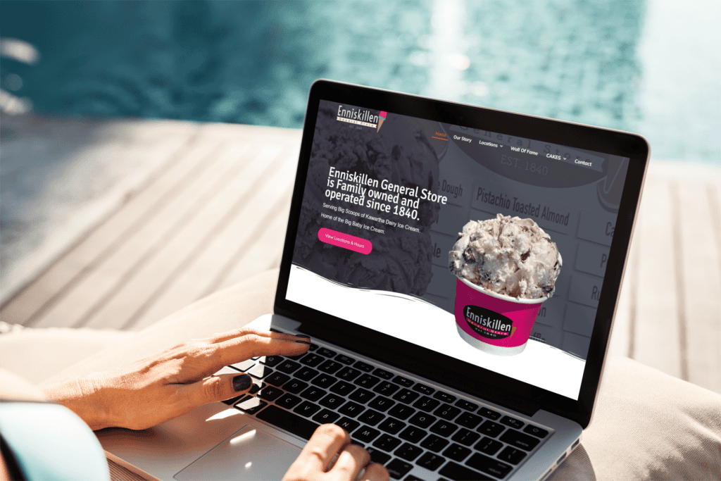 Ice cream shop website on a laptop by a pool in Durham Region.